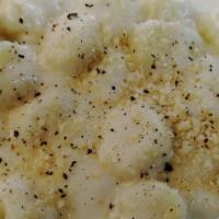 Gnocchi Parmesan Cream · Our Gnocchi (potato dumplings) tossed with Parmesan Cream Sauce, topped with fresh Parmesan ...