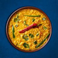 Divine Yellow Lentils  · Yellow lentils cooked with onion, tomato, and sauteed cumin seeds, garlic and chilies.