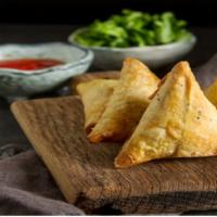 Veggie Samosa · Crispy pastry stuffed with potatoes, peas and spices.