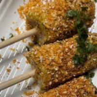 Elotes Locos · Corn on the Cob with Queso Fresco,. Chili Salsa & spicy house crumbs