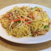Singapore Noodles · Stir-fried thin noodles with curry, shrimp, roast pork, scallions, onions, carrots, and egg.