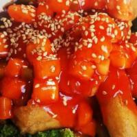 Sesame Tofu · Hot and spicy. Vegan. Deep fried firm tofu with general tso's sauce over steamed mixed veget...