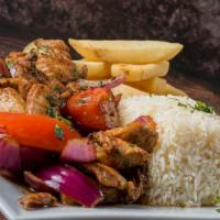 Pollo Saltado · tender chicken breast with red onion and tomatoes served with white rice and fries