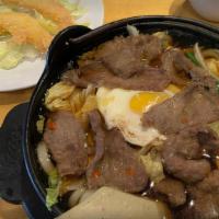 Hot Pot Noodle Soup · Udon noodle in a savory broth, serve with beef, tempura shrimp, egg