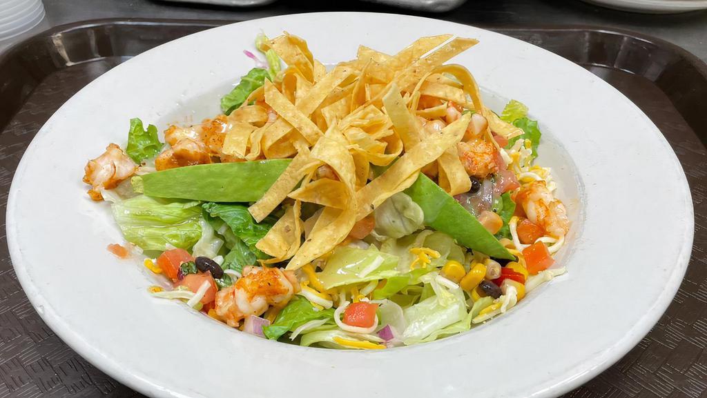 Azteca Salad · Choice of grilled chicken, steak or carnitas lightly tossed with lime dressing, black bean corn relish, avocados, tomatoes, and cheese topped with tortilla strips.