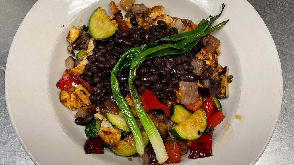 Grilled Fiesta Platter · Mushrooms, bell peppers, onions, zucchini, and tomatoes grilled with your choice of chicken or steak, served with black beans.