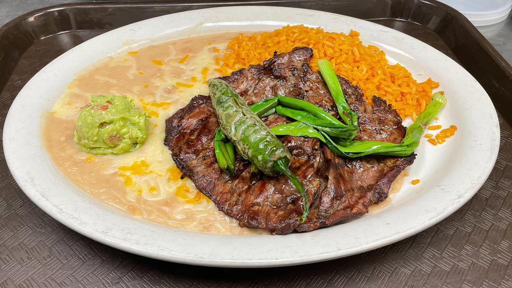 Carne Asada · Tender USDA choice steak grilled in a authentic Mexican style. Garnished with guacamole and grilled green onions.