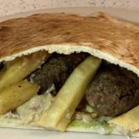 Kofta Sandwich · Minced Lean Beef, Marinated with Parsley & Onions, Served over Lettuce, Tomatoes, Fries, Hum...