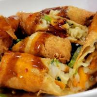 Vegetable Egg Rolls · Deep-fried egg rolls stuffed with cabbage and carrots drizzled with sweet chili and teriyaki...