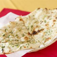 Garlic Naan · A delightful flour bread garnished with garlic and butter.