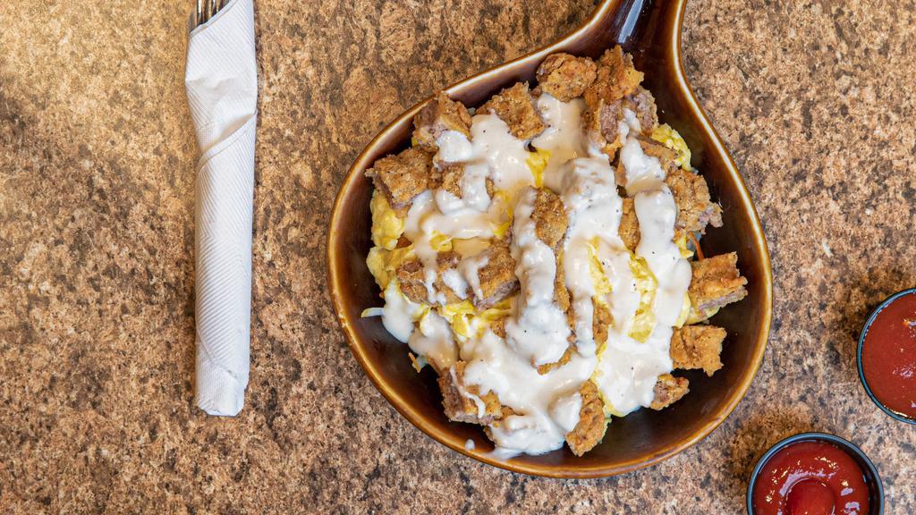 Chicken Fried Steak Skillet · Hash browns topped with two eggs and a sliced chicken fried steak, topped with country gravy.