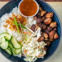 Caribbean Jerk Bowl · Authentic jerk pork with coleslaw, escovitch cucumbers and fry plantains serve with brown st...