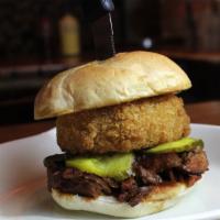 No-Bones-About-It Sandwich · Tender, juicy rib meat, hand breaded onion rings, housemade BBQ sauce & our own sweet pickle...