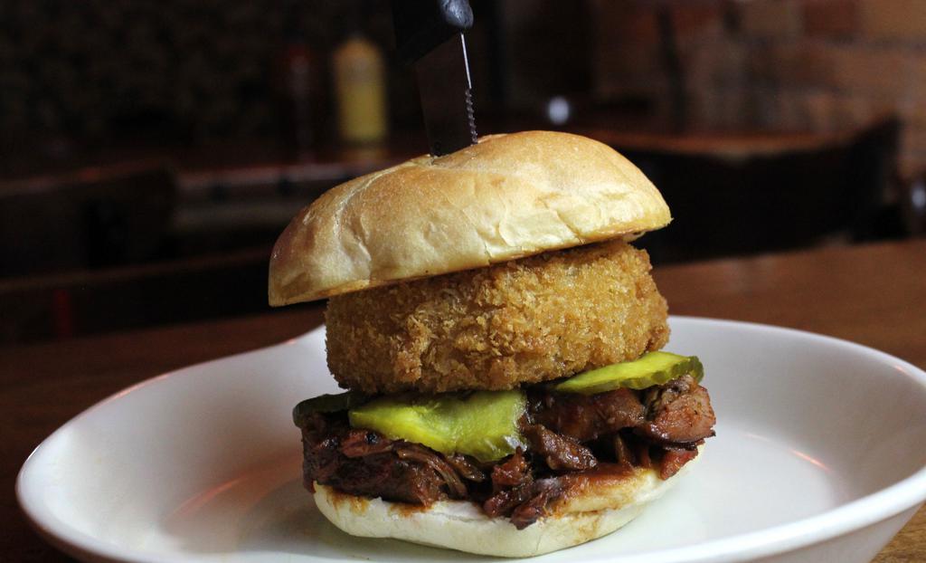 No-Bones-About-It Sandwich · Tender, juicy rib meat, hand breaded onion rings, housemade BBQ sauce & our own sweet pickles on a fresh made bun.
