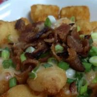 Nobull Poutine · Tater tots, wisconsin cheese curds, bacon bits, green onions smothered in our signature gravy.
