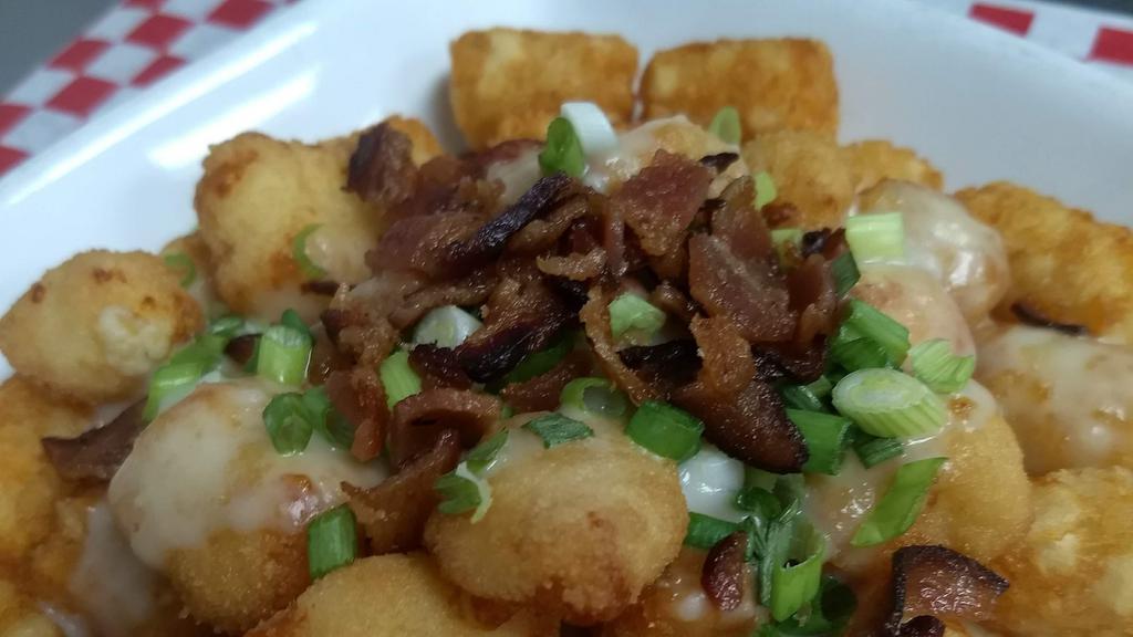 Nobull Poutine · Tater tots, wisconsin cheese curds, bacon bits, green onions smothered in our signature gravy.