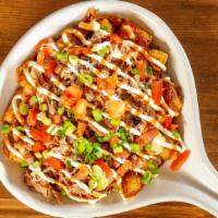 Pork Tot-Chos · Tater tots, pulled pork, cheese sauce, tomatoes, green onions, sour cream & spicy BBQ sauce.