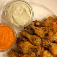 Buffalo Chicken Wings · Brick oven baked and tossed in house made buffalo sauce. Served with blue cheese and buffalo...