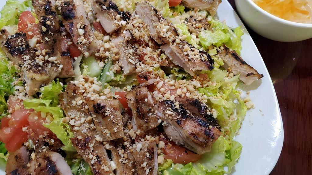 Vietnamese Salad With Grilled Chicken Thigh (Gỏi Gà Nướng) · Contains nuts. Includes grilled chicken thigh, lettuce, tomatoes, cucumbers, pickled carrots, and topped with crushed peanuts.