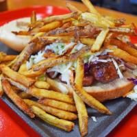 The Kc Boy · Open face, smoked, Polish sausage sandwich with slaw and fries on top.