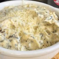 Spinach Artichoke Dip · Savory cream based dip infused with wilted spinach and chopped artichoke hearts, garnished w...