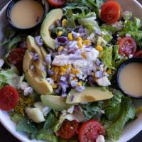 Southwest Cobb Salad · Chopped romaine lettuce mixed with tomato, roasted corn, black beans, cucumber, feta cheese,...