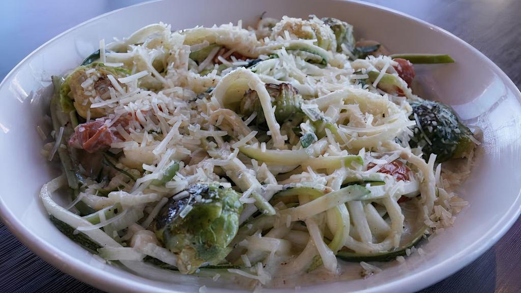 Zucchini Pasta · Roasted brussels sprouts, blistered cherry tomatoes, and a mix of garlic and herbs, served on a bed of spiraled zucchini with alfredo sauce and topped with parmesan cheese.