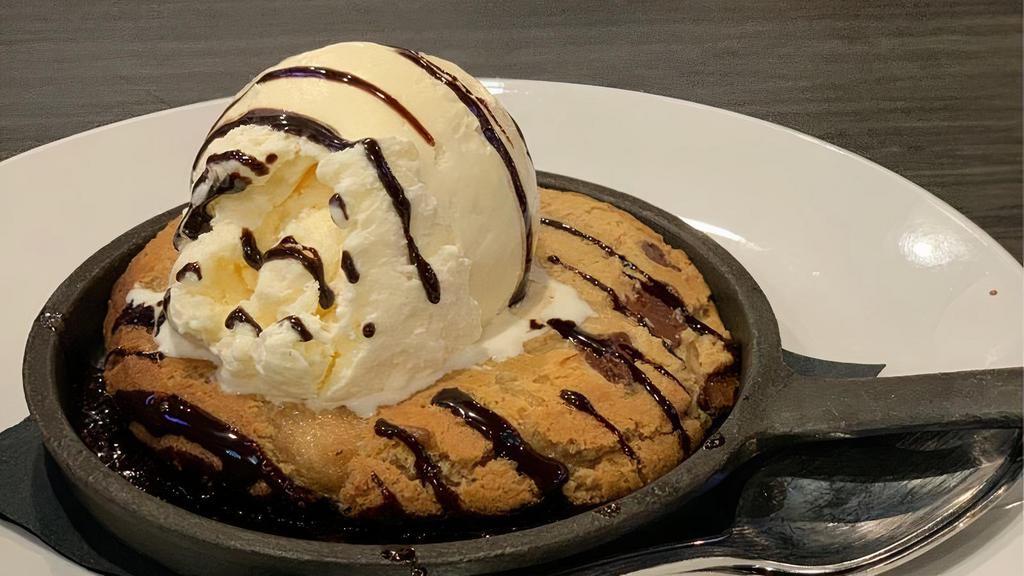 Chocolate Chip Cookie Skillet · Freshly baked chocolate chip cookie topped with vanilla bean ice cream and chocolate syrup.