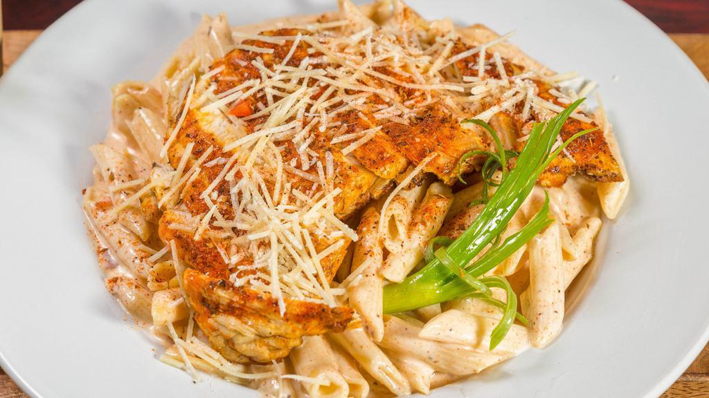 Blackened Chicken Pasta · Penne pasta tossed in a parmesan cream sauce with bell peppers, topped with blackened chicken breast and parmesan cheese.
