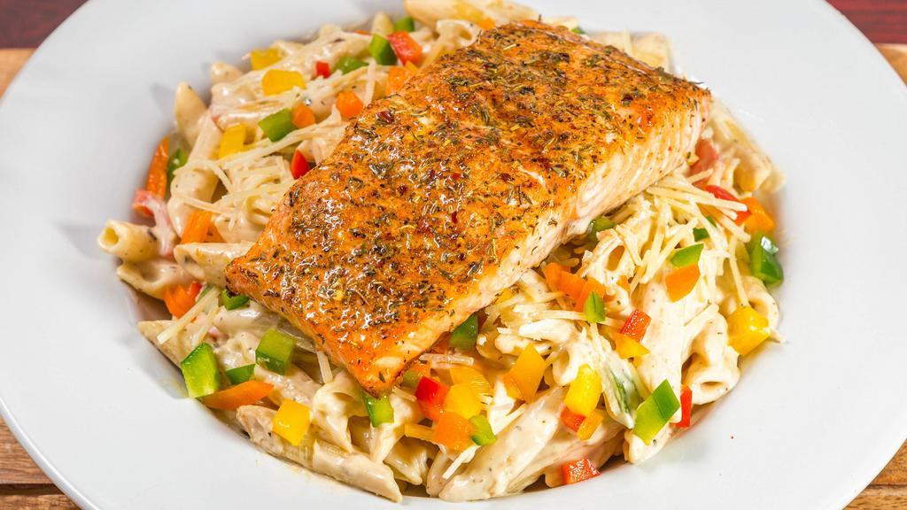 Salmon Rasta Pasta · Penne pasta tossed in a parmesan cream sauce with bell peppers, topped with our grilled jerk salmon and parmesan cheese.