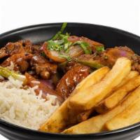 Pollo Saltado · Chunk of chicken, red sautéed onions, tomatoes, soy sauce, and spring onions served on a bed...