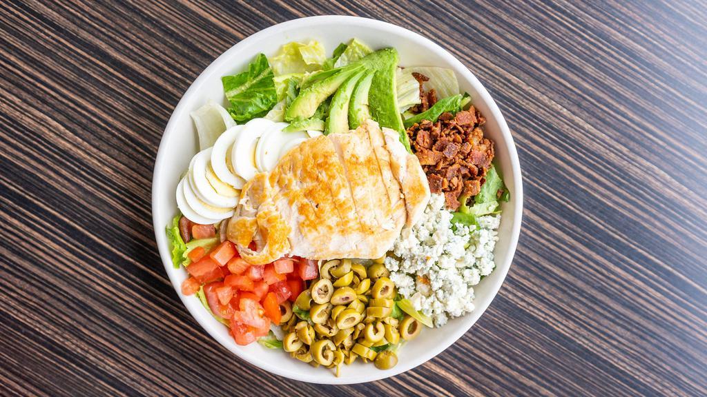 Cobb Salad (No Chicken) · Fresh greens, crispy bacon, tomato, egg, bleu cheese crumbles, green olives, avocado, and your choice of dressing.