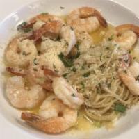 Shrimp Scampi · Tender sautéed shrimp with fresh tomatoes in savory garlic butter sauce atop angel hair past...
