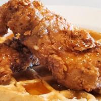 Chicken & Waffles · Two pieces of our hand breaded  buttermilk chicken strips with a fluffy Belgian waffle and s...