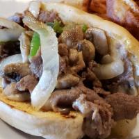 Philly Cheese Steak · Beef, onions and peppers smothered in melted Swiss cheese on a hoagie bun.