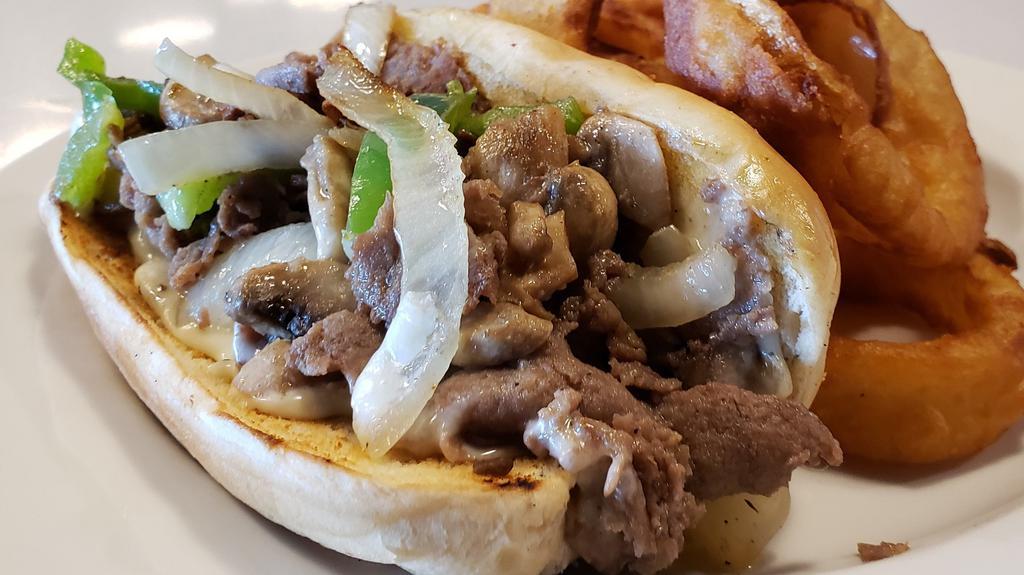 Philly Cheese Steak · Beef, onions and peppers smothered in melted Swiss cheese on a hoagie bun.
