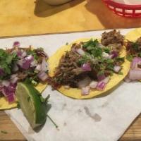 Amores Tacos · Gluten-free. Three carnitas street tacos topped with cilantro and onion. Served with a side ...