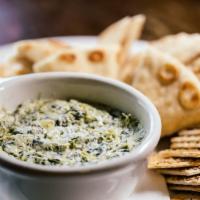 Spinach Artichoke Dip · Spinach artichoke dip warmed and served with assorted crackers.