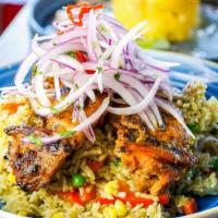 Arroz Con Pollo · “Rice & Chicken” simmered in cilantro, herbs and vegetables.
