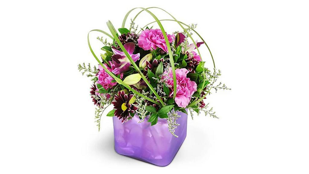 Crazy In Love · Show her how crazy in love you are with this passionate purple arrangement. It's a modern yet so classic way to show her you adore her, and you'll see how much she adores you for sending it!

Stunning purple dendrobium orchids take center stage, with fuchsia carnations, purple daisies, and more - all topped off with a modern twist of bear grass!

Approximately 12