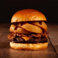 The Bacon Bbq Burger · Beef patty, bacon, fried onion rings, BBQ sauce, and melted cheddar cheese on a brioche bun.