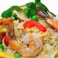 Pineapple Fried Rice · Stir-fried rice, shrimps, egg, pineapple, cashew nuts, scallions, onions & egg