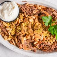 Rice With Lamb · rice with ground beef topped with shredded lamb and roasted nuts served with yogurt.