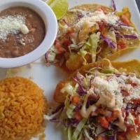 Grilled Fish Tacos · Two tacos with grilled white fish topped with cabbage, pico de gallo, sour cream and cheese....