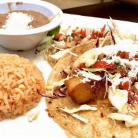 Baja Fish Tacos · Battered white fish fried to perfection topped with cabbage, pico de gallo, sour cream & che...