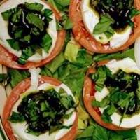 Mozzarella Vesuvio/ Caprese Salad · Fresh mozzarella cheese with olive oil & light basil sauce on fresh tomatoes.
