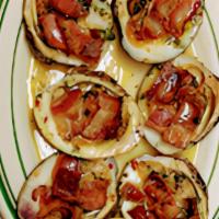 Clams Casino · Half dozen of top neck clams baked in basil butter sauce with smoked bacon.