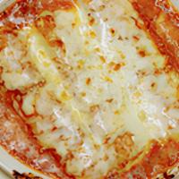 Baked Manicotti · Pasta crepes filled with ricotta cheese baked in tomato sauce and topped with mozzarella che...