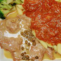 Veal Piccata · Veal scaloppini sauteed in white wine lemon sauce with capers. Served with garlic bread.