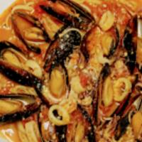 Mussels And Calamari · Fresh mussels and calamari cooked in white wine lemon butter sauce and clam juice. Served ov...